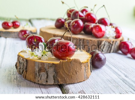 Red cherries, heap merry on wooden rustic plate