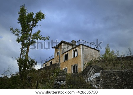 Abandoned building with dark clouds as a background 