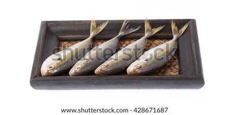 Small fishes on bamboo woven tray isolated on white background