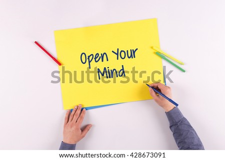 Hand writing Open Your Mind on yellow paper