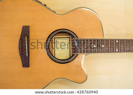 Guitar ,music instrument on wooden background.