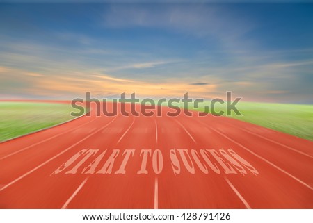 Start to Success written on running track  with green grass and blue sky white cloud background
