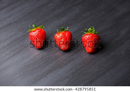 tasty strawberries isolated on black background - stone tile