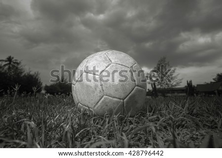 Soccer ball on the grass in black and white.