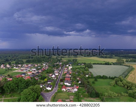 aerial view of  storm clouds over a small village in germany