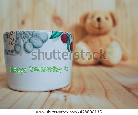 Massage " Happy Sunday" on a coffee cup with teddy bear and wooden background. vintage style. inspiration quote.