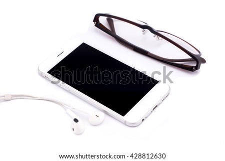 Smart phone  and headphone,glasses on white table