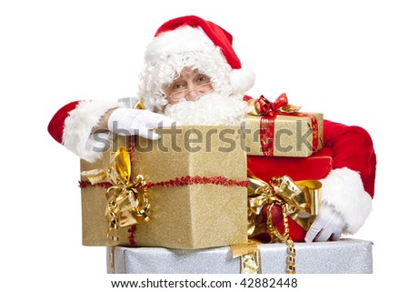Santa Claus is leaning on Stack of Christmas presents. Isolated on white.