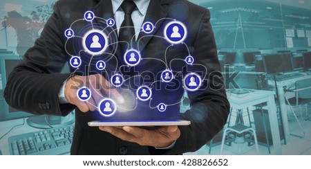 Businessman using the tablet for social connection on blurred photo of computer room background, Elements of this image furnished by NASA, Business network concept