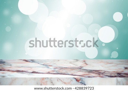 white marble stone countertop or table on green-blue blurred abstract background / empty marble / for display or montage your products