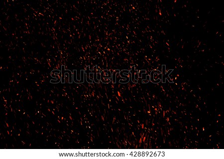 sparks from the fire on a black background