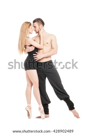 Woman in ballet shoes hugging with topless sportsman