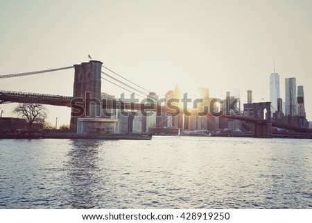 Blurred of of Brooklyn Bridge and Manhattan skyline at sunset in vintage colour