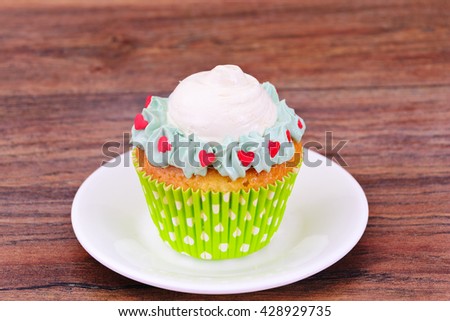 Cake with Cream, Cupcake on Wood Background. Studio Photo