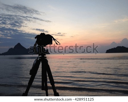 Camera with sunset sea