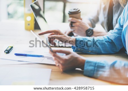 Woman Touching Digital Tablet Hand.Reflections Screen.Project Producers Researching Process.Young Business Crew Working with New Startup Studio. Blurred,film effect. Horizontal photo