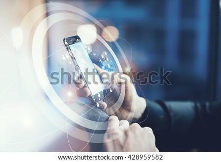 Photo businessman relaxing modern loft office. Man sitting in chair at night.Using contemporary smartphone. Digital Connections World Wide Interfaces Screen. Horizontal,film effect,blurred background