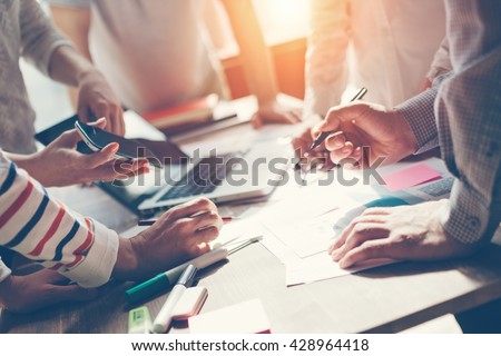 Team work process. Marketing strategy brainstorming. Paperwork and digital in open space. Intentional sun glare Royalty-Free Stock Photo #428964418