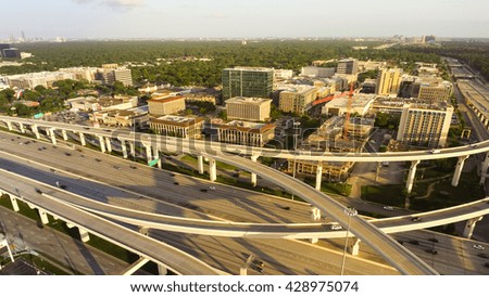 Aerial view massive highway intersection, stack interchange with elevated road junction overpass at late afternoon in Houston, Texas. This five-level freeway interchange carry heavy traffic, panorama.