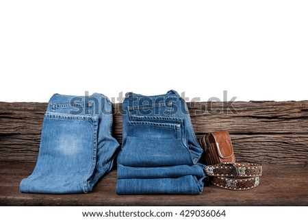 jeans on white background,blue jeans,jeans and cowboy belt , leather pocket on wooden
