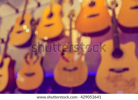 Abstract Blurred image of musical instrument shop with bokeh for backgrund usage . (vintage tone)