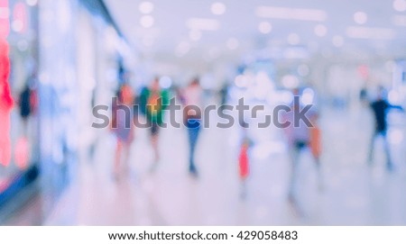 vintage tone blurred image of shopping mall and people for background usage .