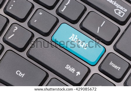 Computer keyboard closeup with "About" text on gblue enter key