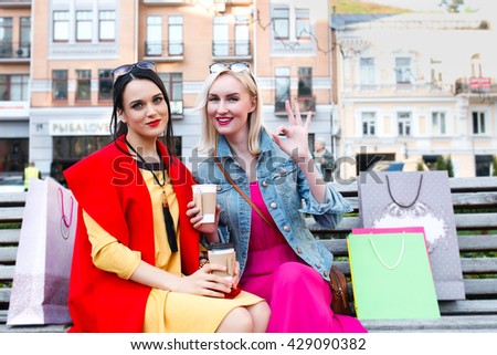 sale and tourism, happy people concept - beautiful women with shopping bags in the city