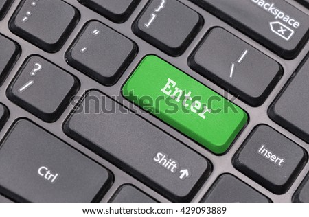 Computer keyboard closeup with "Enter" text on green enter key