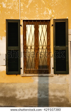 shutter europe  italy  lombardy       in  the milano old   window closed brick      abstract grate