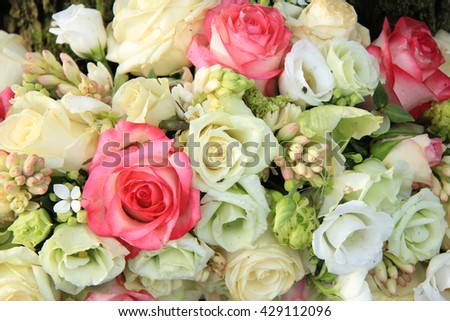 Pink and white roses in a wedding arrangement