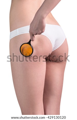 Woman checking cellulite with magnifying glass