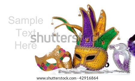 Several mardi gras masks with gold, purple, green and white with copy space on a white background