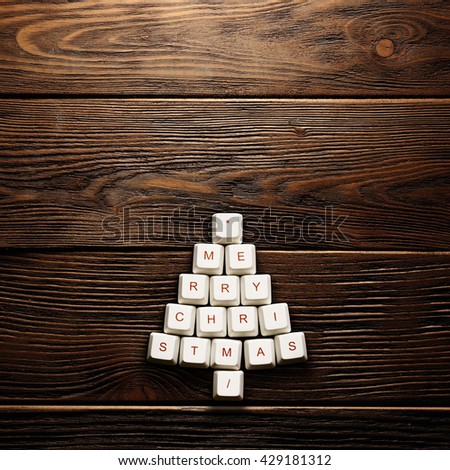 Christmas card - Christmas tree made of computer keys,wooden background
