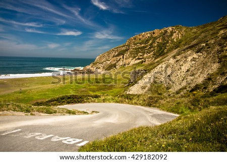 travel idea to beautiful scenic sandy beach azkorri in springtime in blue sky, basque country, spain