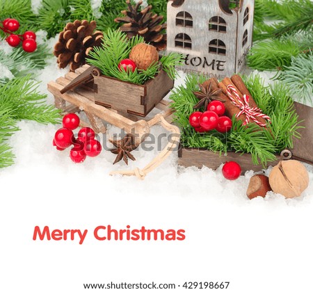 Wooden boxes on sledge and a candlestick on snow on a white background. A Christmas background with space for the text.