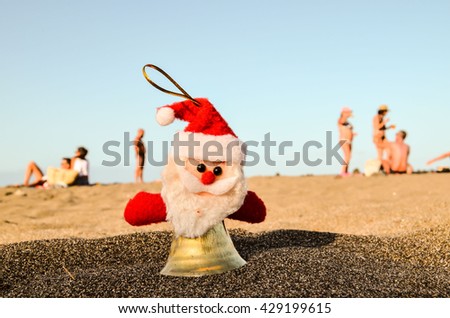 Photo Picture of Santa Claus Toy on the Sand Beach