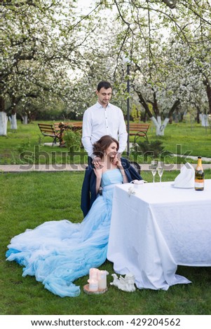 Groom and bride together, wedding couple. Young couple embracing in blooming spring garden. Love and romantic theme