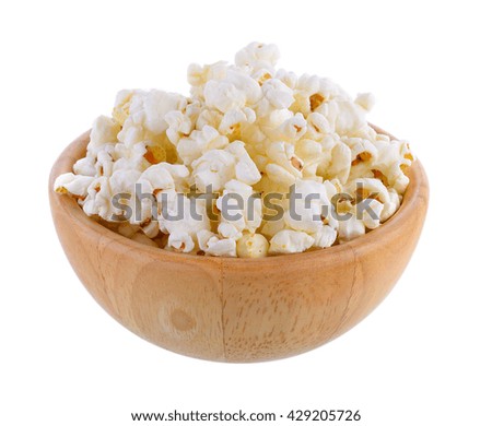 popcorn in wood bowl isolated on white background