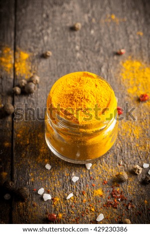 Macro photo of turmeric powder with spices. Yellow curry.