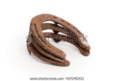 Stack of old rusty horseshoes, isolated on a white background