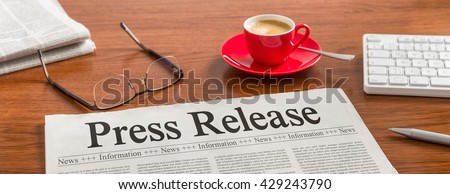 A newspaper on a wooden desk - Press Release Royalty-Free Stock Photo #429243790