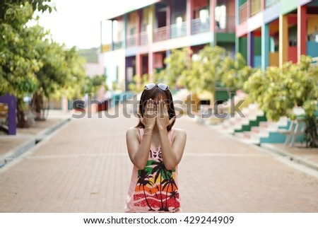 Girl with her hands covering face