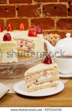 Delicious biscuit cake with fresh strawberries and biscuit cream. macro on a plate.