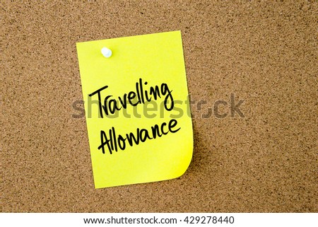 Travelling Allowance written on yellow paper note pinned on cork board with white thumbtack, copy space available Royalty-Free Stock Photo #429278440