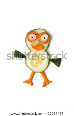 Food art creative concepts. Funny penguin made of cucumbers and carrots isolated on a white background.