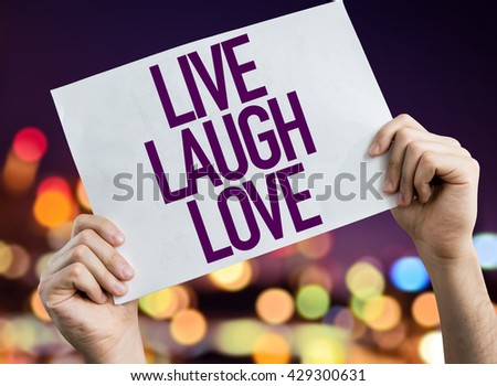 Love Laugh Love placard with bokeh background