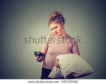 beautiful sleepy woman with a pillow in hand