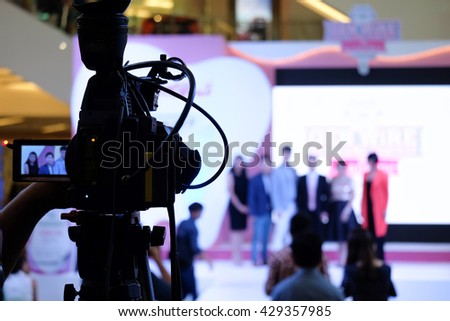 Photographer video recording activity within the event on Stage Royalty-Free Stock Photo #429357985