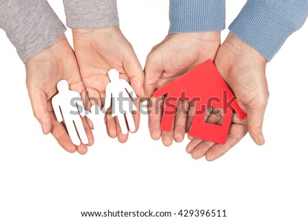 Hands holding a paper home and family on white background, protection concept
